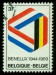 BELGIE.  symbol je tvořený vlajkami jednotlivých zemí Beneluxu